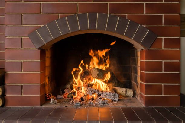 Fire burning under a brick arch in a well-kept firebox