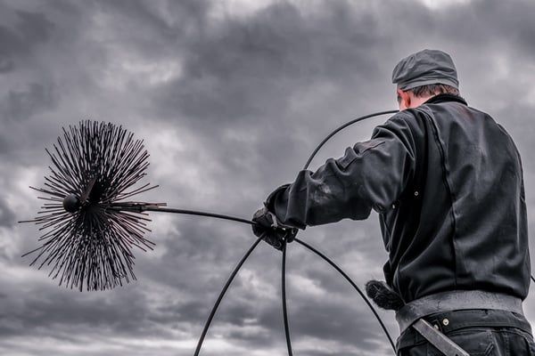 Sweep readying a brush loop beneath heavy Sound-side clouds